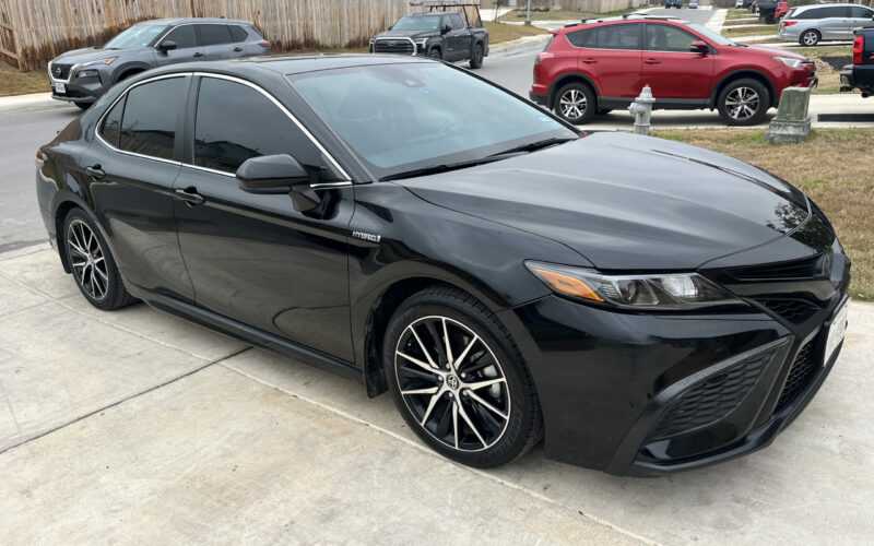 Black Toyota Camry parked in a residential driveway — we come to you