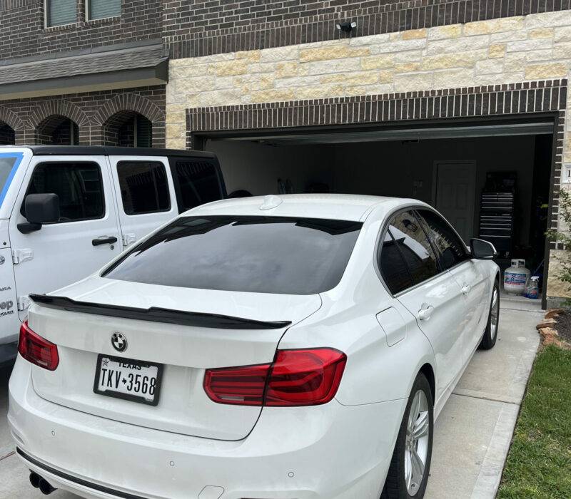 White BMW sedan in a residential garage
